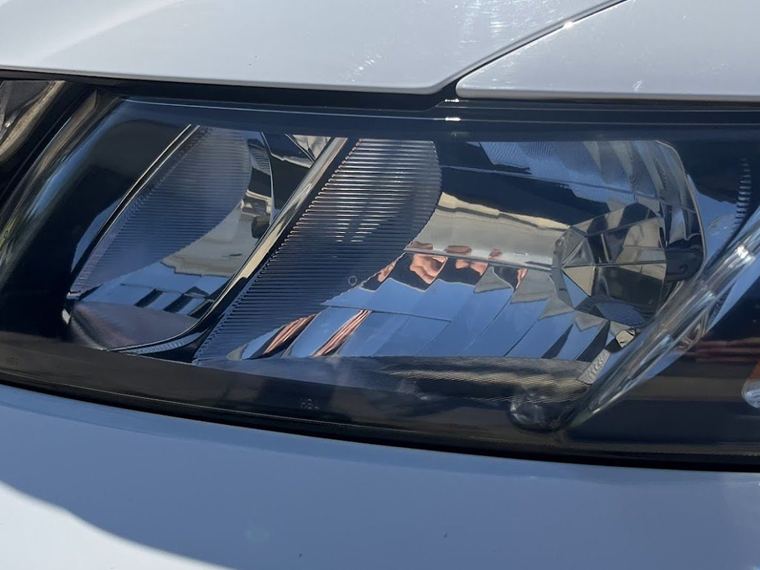 The same headlight lens clear and polished after restoration