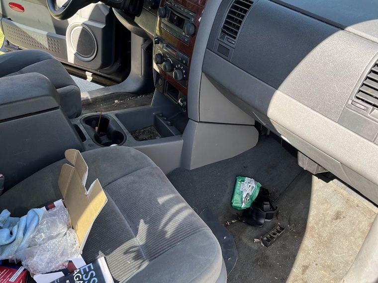Soiled cloth seats and dashboard before an interior detail
